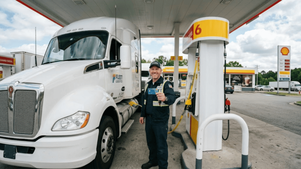 Fleet driver using fleet fuel cards while refueling a semi-truck at a gas station, highlighting efficient fuel management and driver accountability in fleet operations.